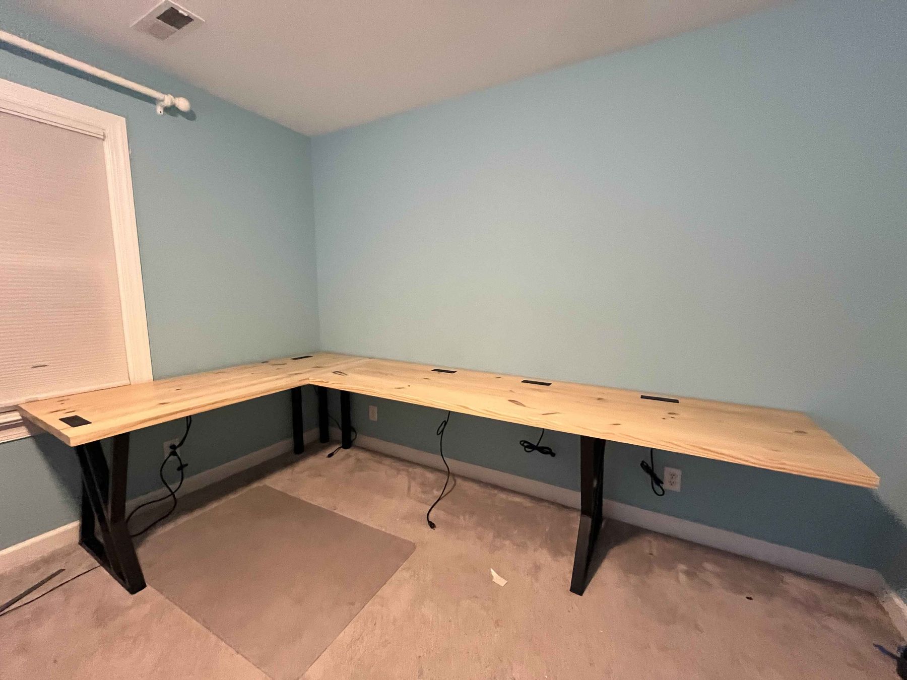 Large L-shaped pine desk on steel legs